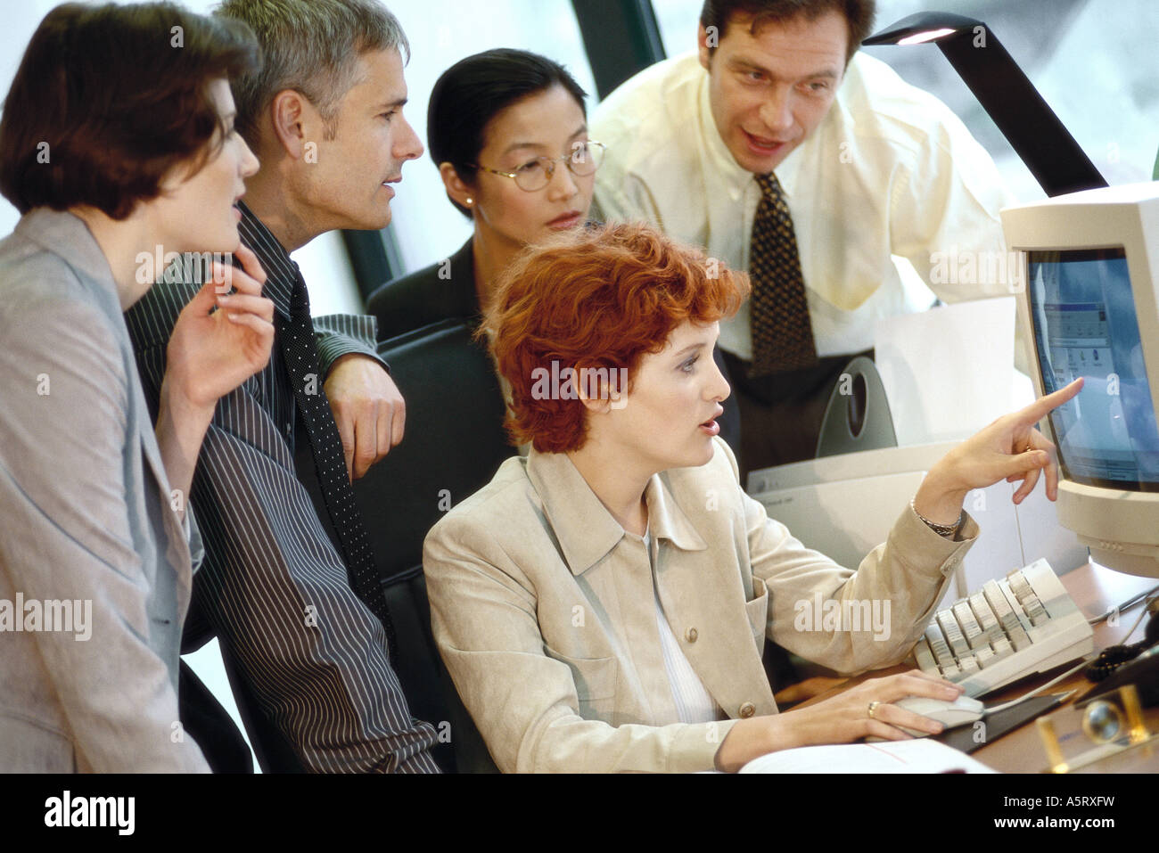 Business persons around desktop hi-res stock photography and images - Alamy