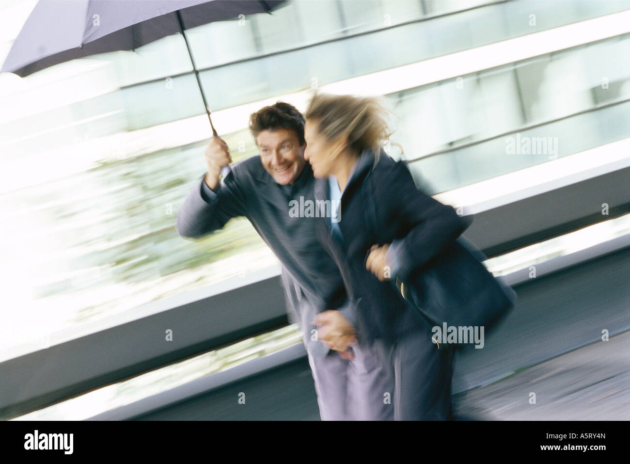 Woman protecting under umbrella hi-res stock photography and images - Alamy