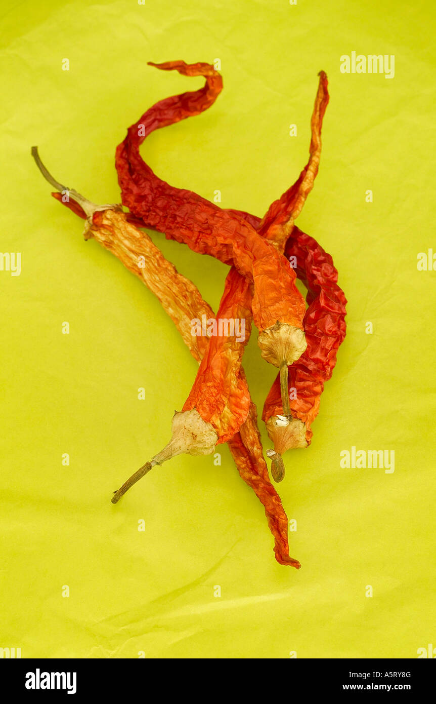 Red hot chili peppers on green background Stock Photo - Alamy