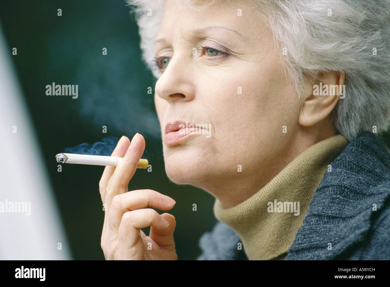Senior woman smoking Stock Photo