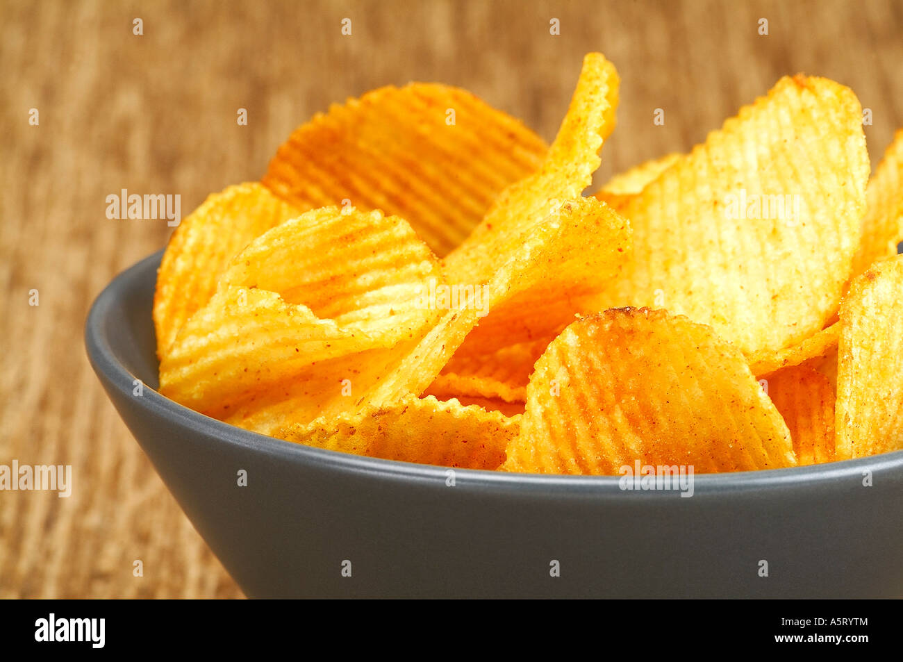 Bowl of crisps on brown cloth Stock Photo Alamy