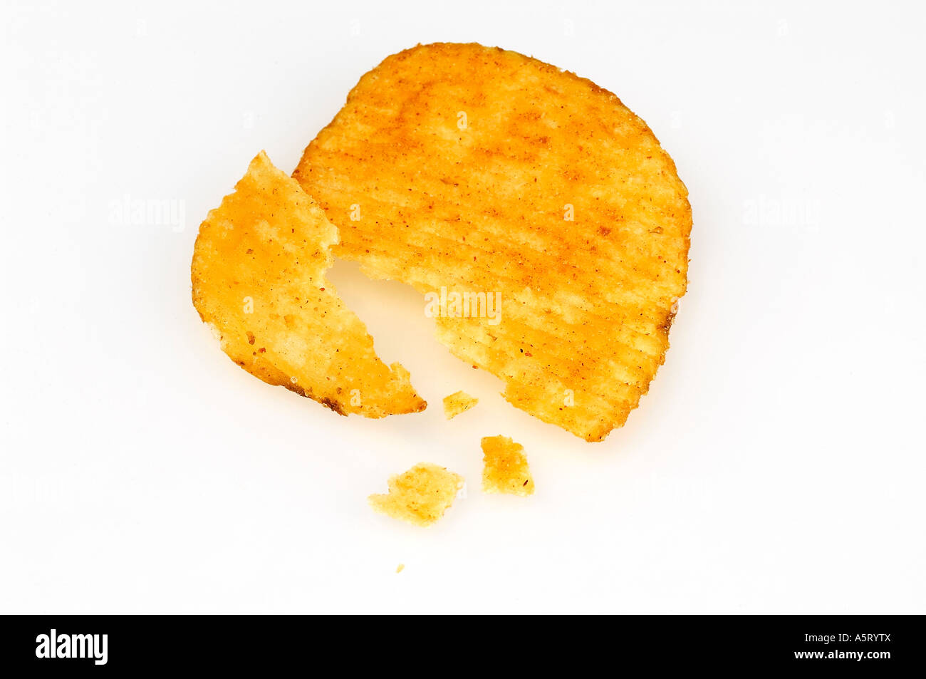 Broken flake of crisps and crumbs on white background Stock Photo Alamy