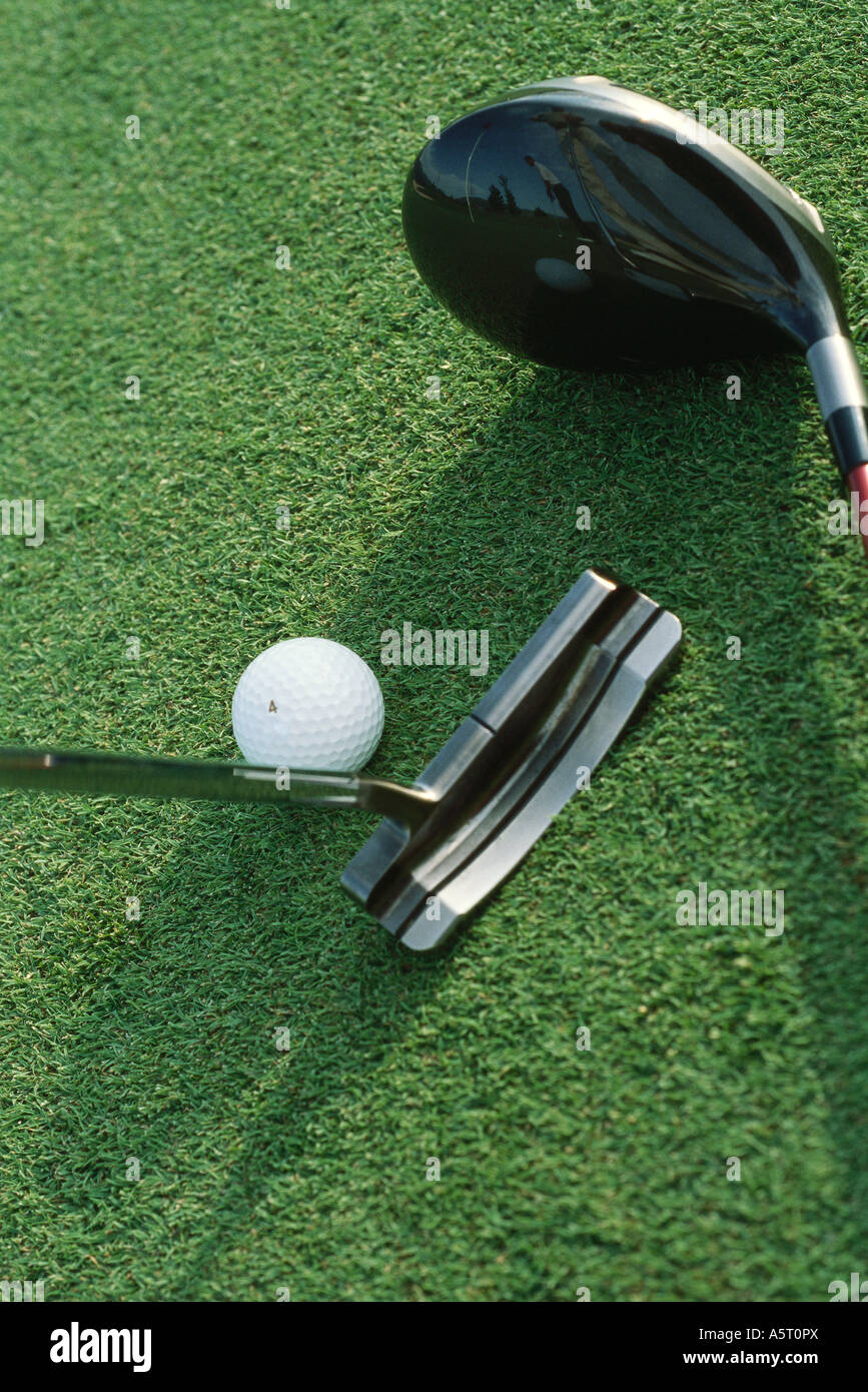 Putter, driver and golf ball on turf, closeup Stock Photo Alamy