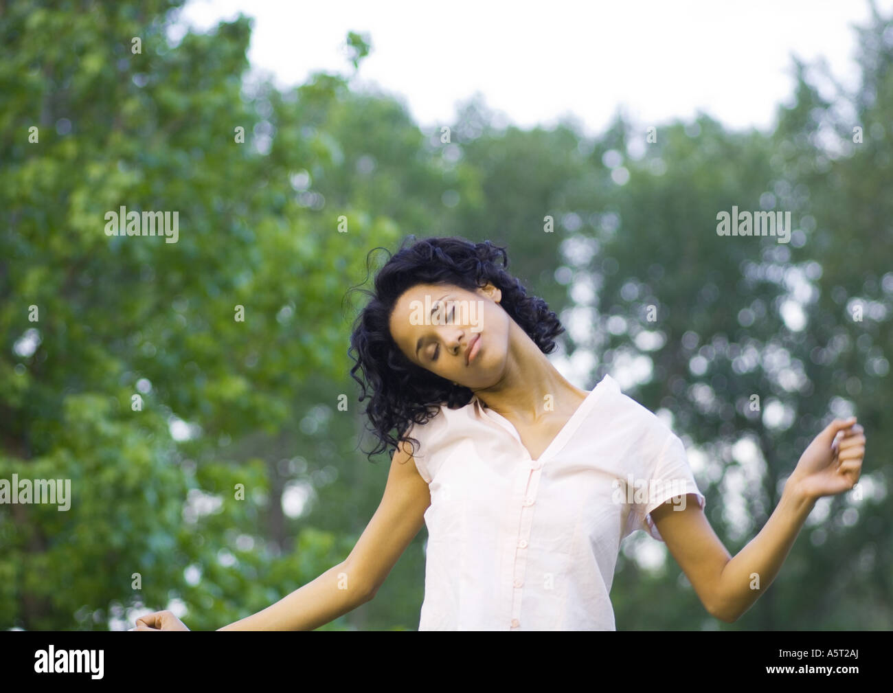 Young woman stretching neck Stock Photo - Alamy