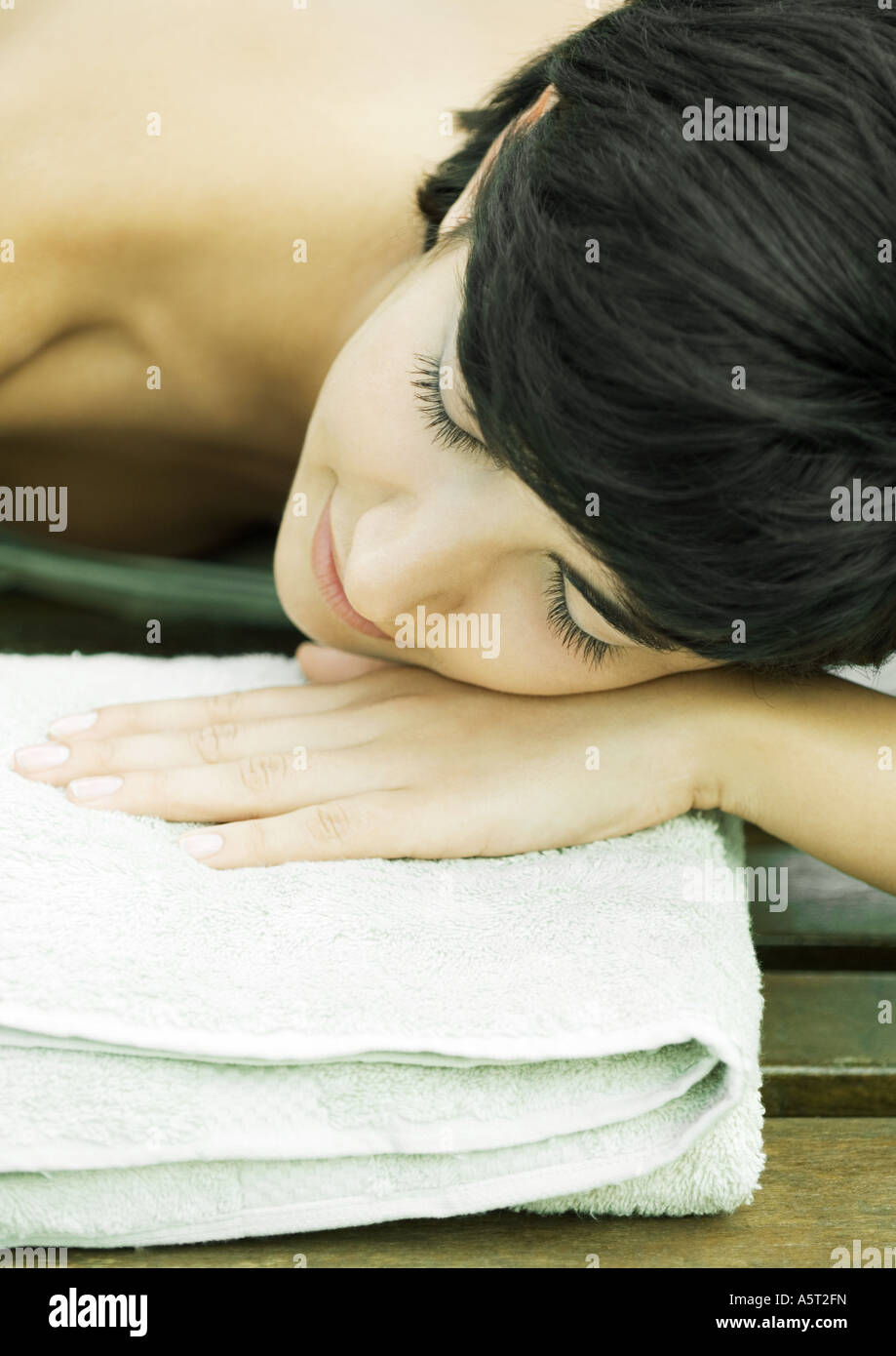 Woman lying with head on towel Stock Photo