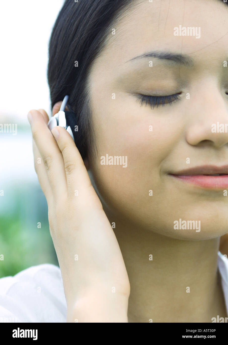 Woman listening to earphones Stock Photo