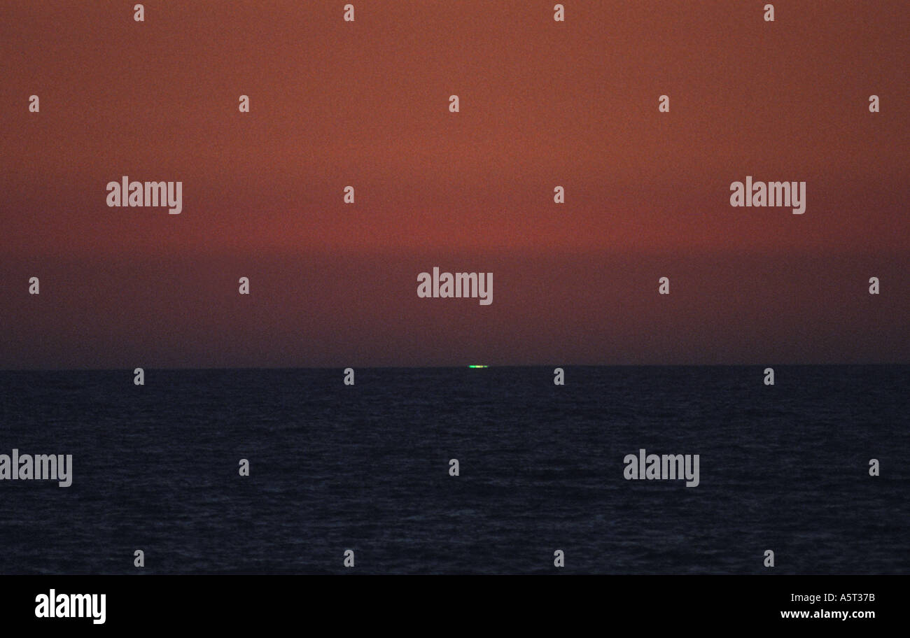 GREEN FLASH Last piece of sun turns emerald green due to differential refraction Baja California MEXICO Stock Photo