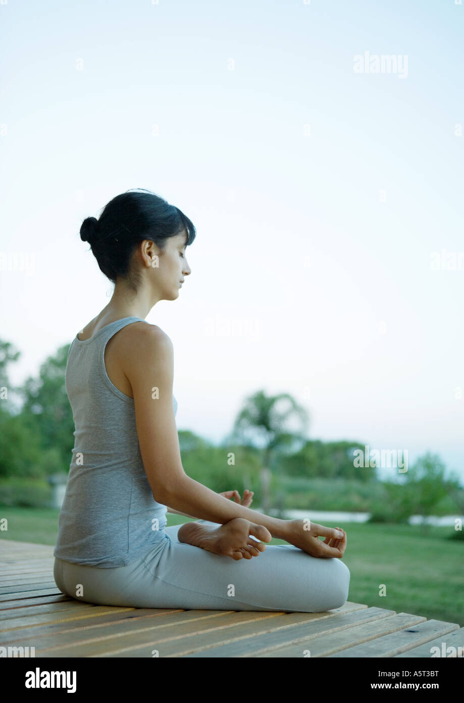 Woman sitting in lotus position Stock Photo