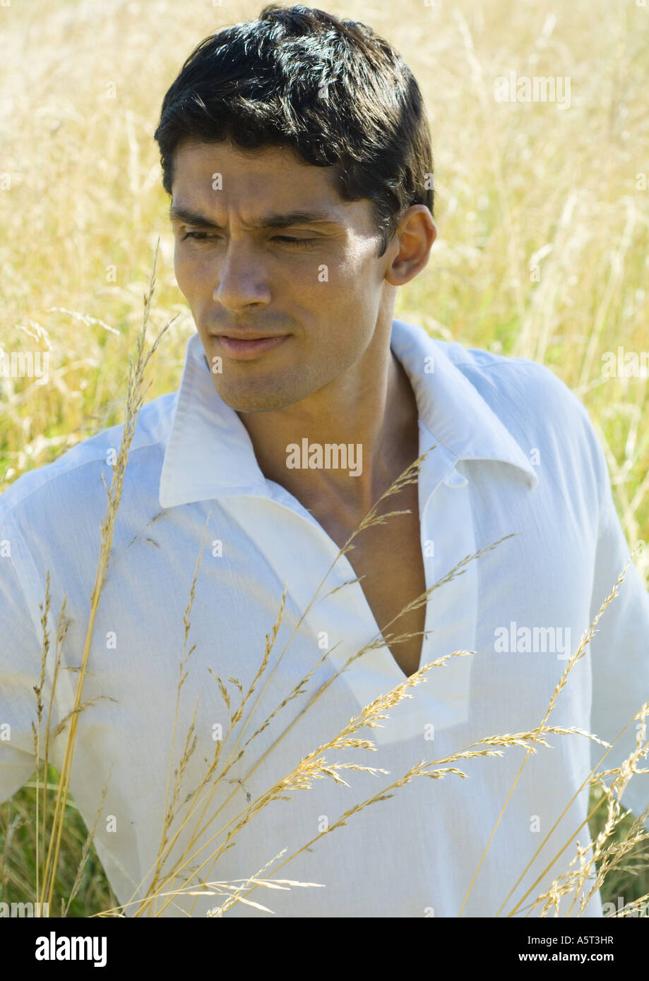 Man standing in field, portrait Stock Photo