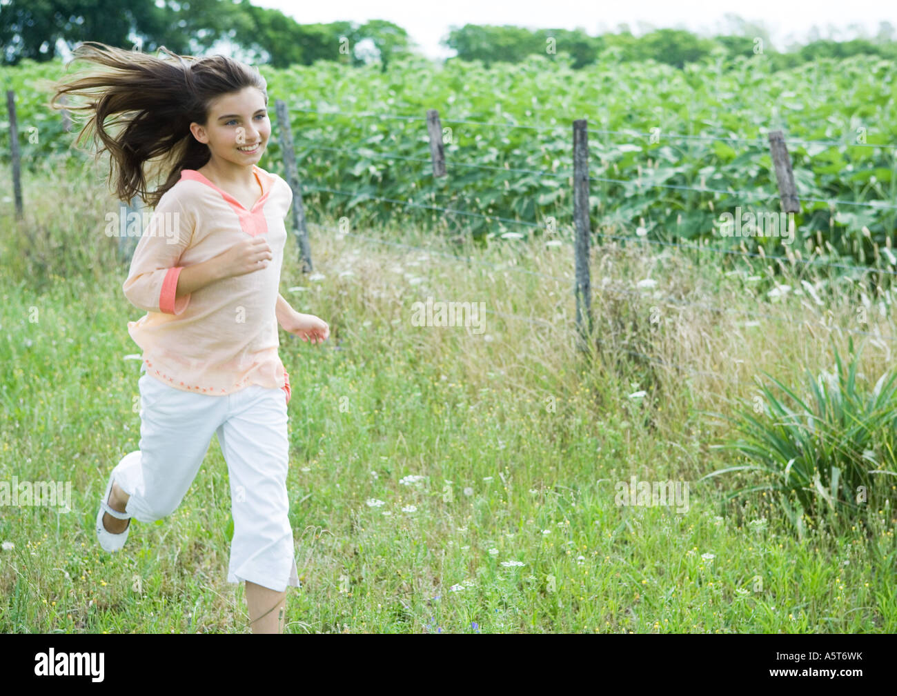 Girl running in field Stock Photo Alamy