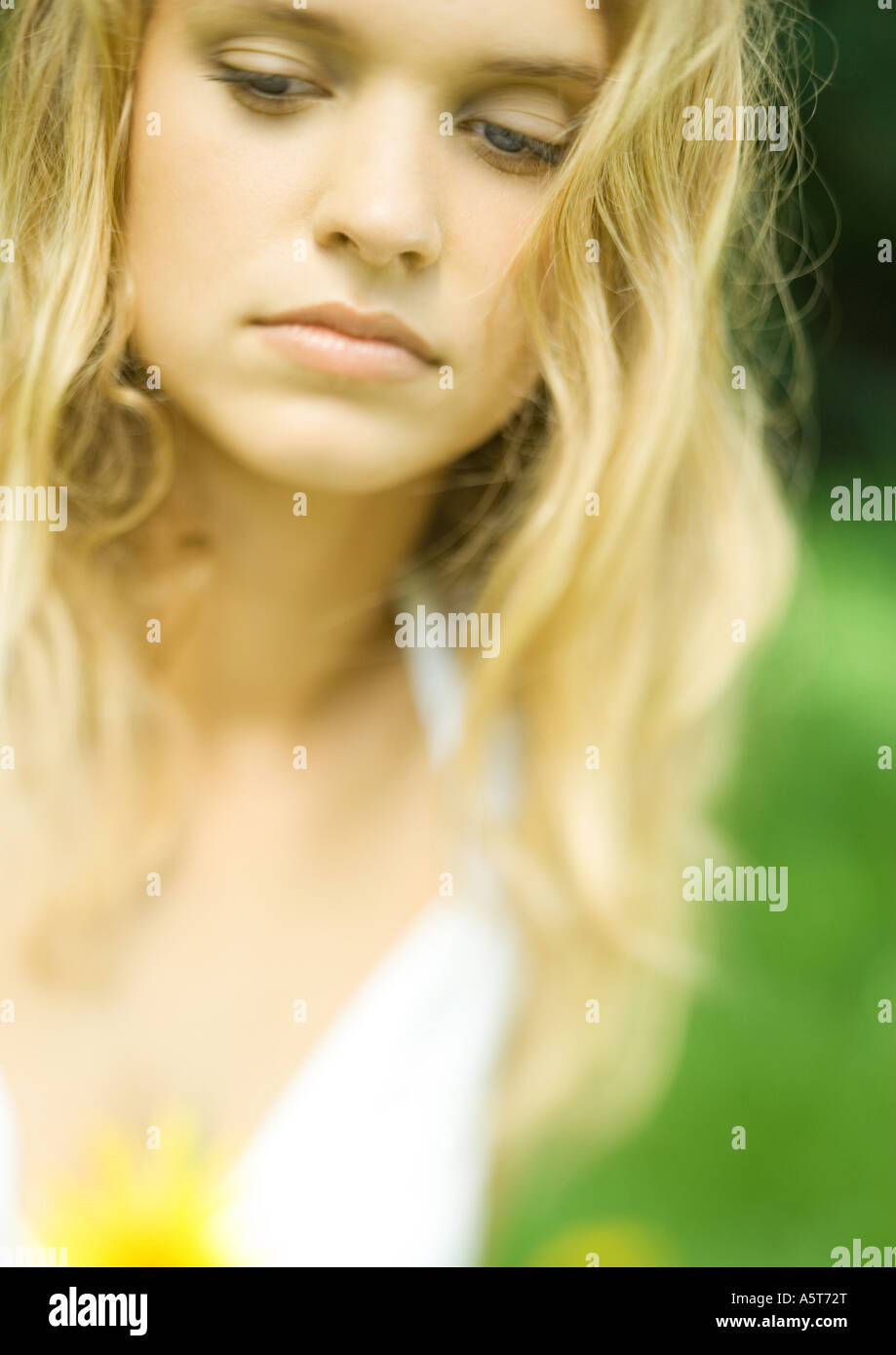 Young woman, eyes lowered, portrait Stock Photo - Alamy