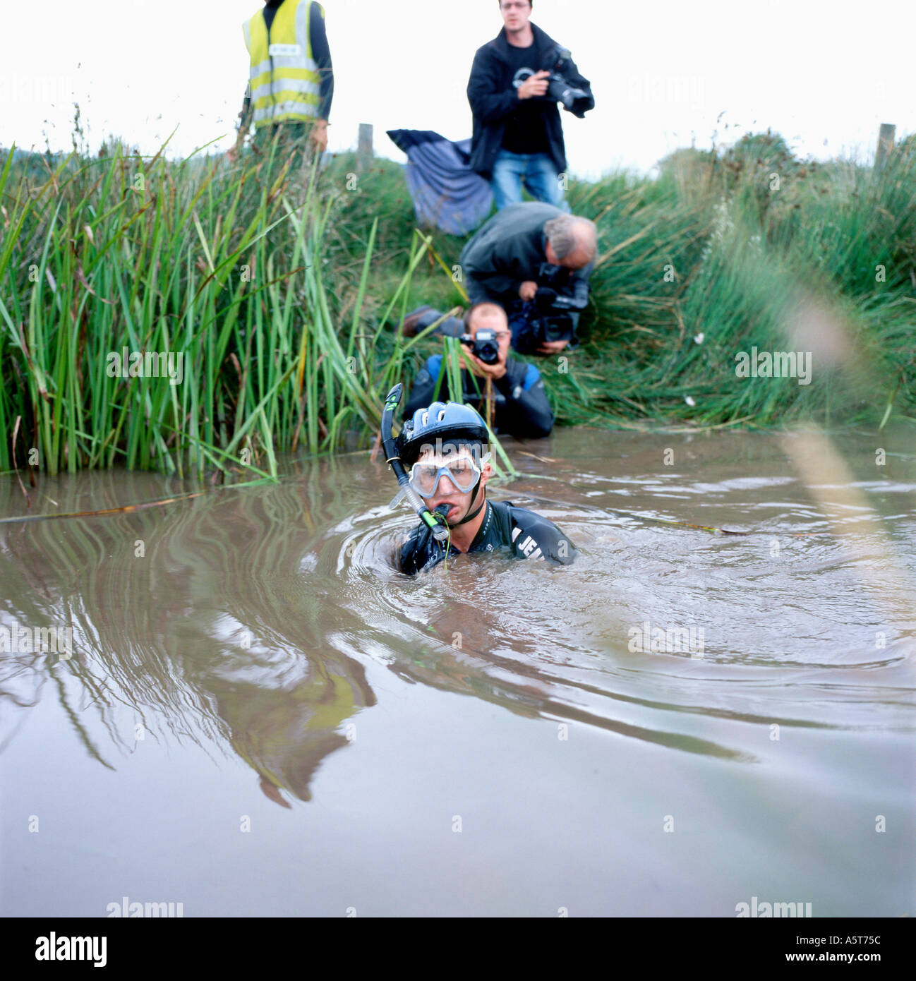 Man emerging from bog at bog snorkelling mountain bike competititon Llanwrtyd Wells Powys Wales UK Stock Photo