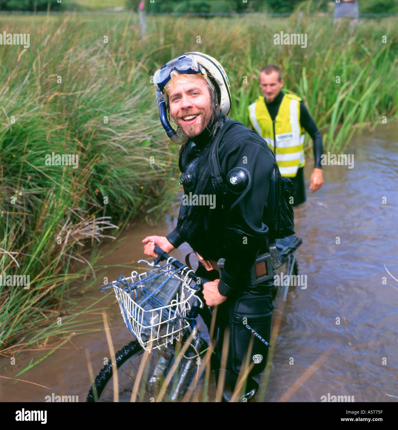 Man coming out of bog at the bog snorkelling mountain bike competititon Llanwrtyd Wells Powys Wales UK Stock Photo