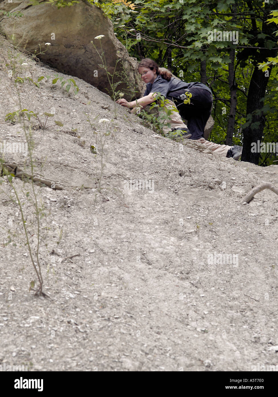 Teen girl searching for fossils on the slope of the at Rock Glen