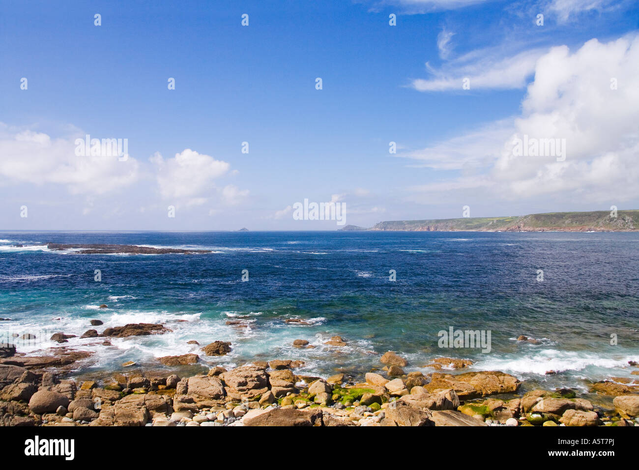 "Sennen Cove" on a sunny summers day with blue sky and white clouds in sunshine near Lands End