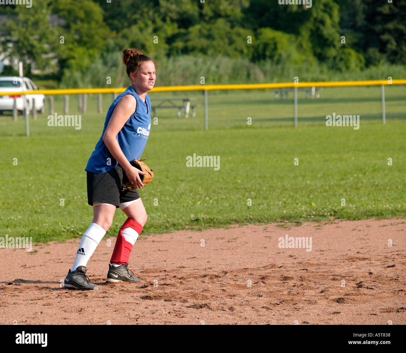 Youth girls softball infielder prepares for the pitch Stock Photo