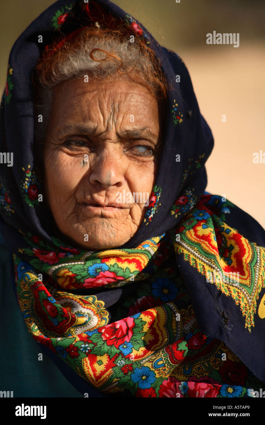 Vertical close up portrait of elderly nomadic berber woman in traditional dress, Tunisia, North Africa Stock Photo