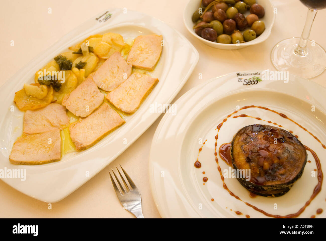Aubergine with fresh cheese and honey loin with potatoes olives El Seco restaurant UBEDA Jaen province Andalusia region Spain Stock Photo