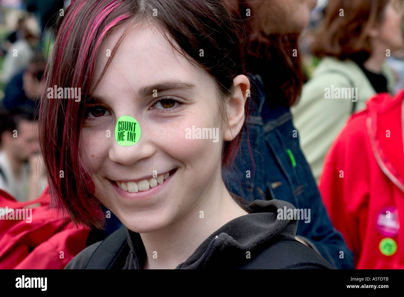 The cute young woman wears a 'count me in' sticker on her nose as she partcipates in the pro-choice march in Washington, DC. Stock Photo