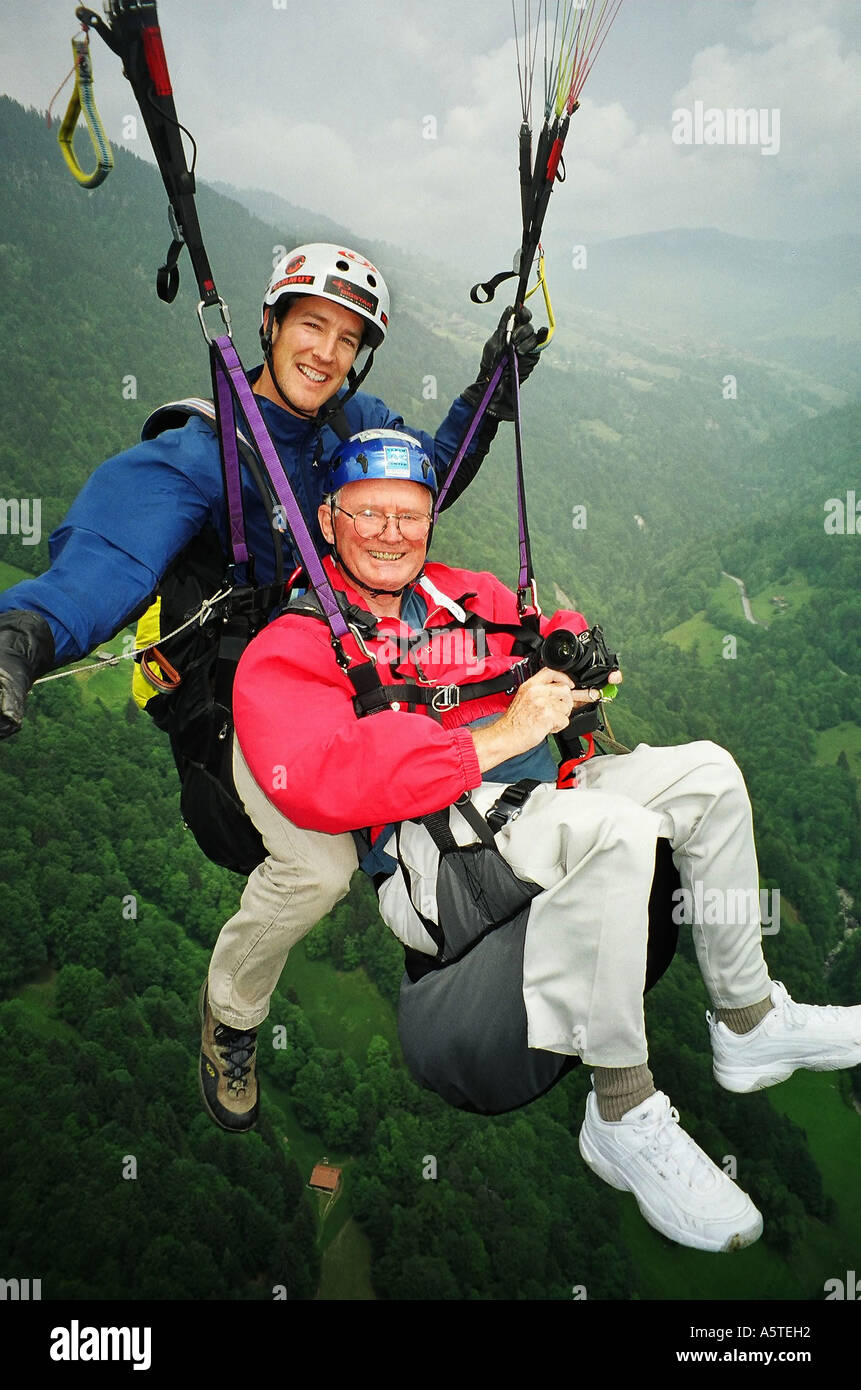 Carl Purcell and pilot parasail over the valley of Interlaken in Switzerland (model released) Stock Photo