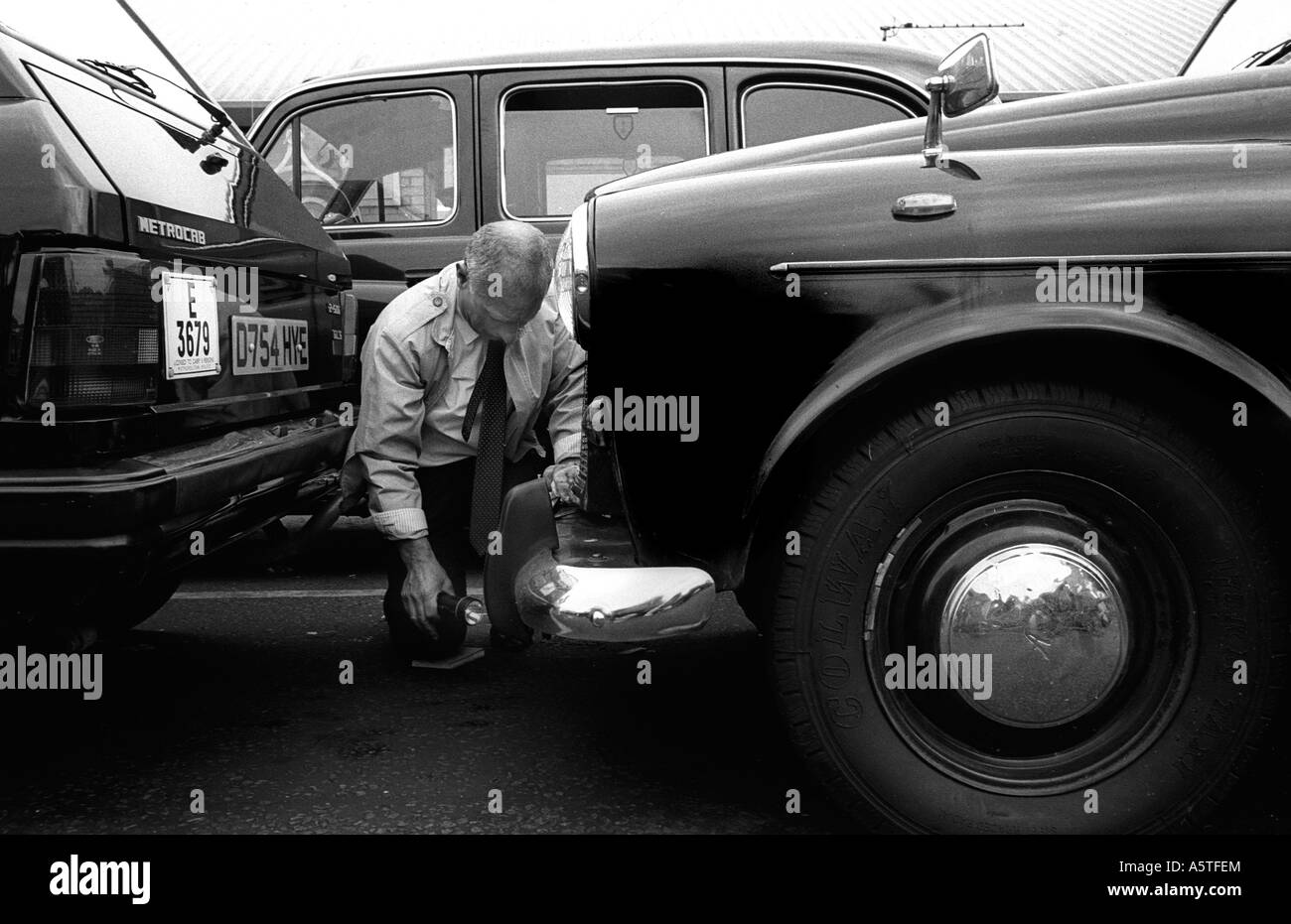 A Public Carriage Office inspector checking London taxis at Heathrow Airport. Stock Photo