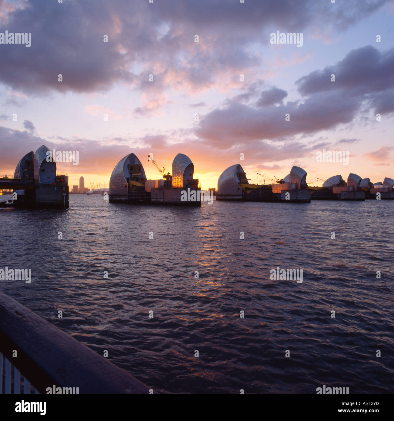 The Thames Barrier at Dusk with Canary Wharf Stock Photo - Alamy