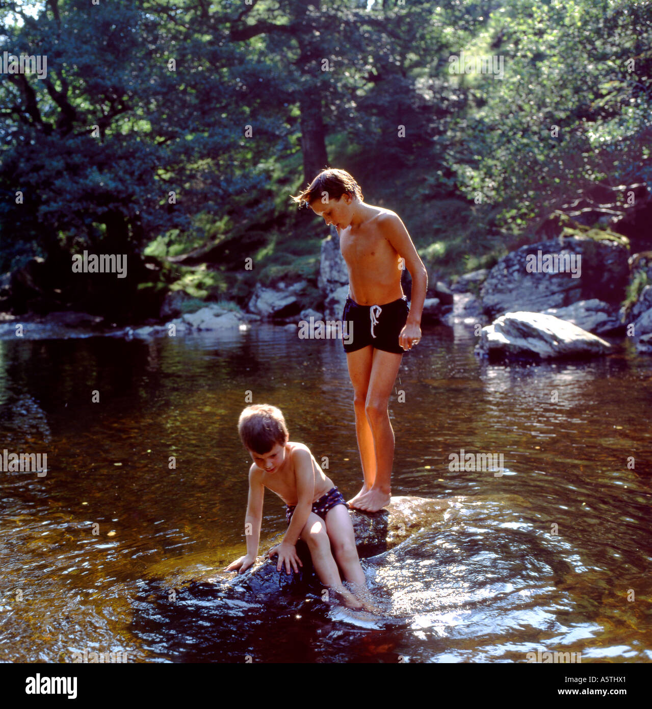 Children boys kids friends playing outside in nature wild swimming in Stock  Photo - Alamy