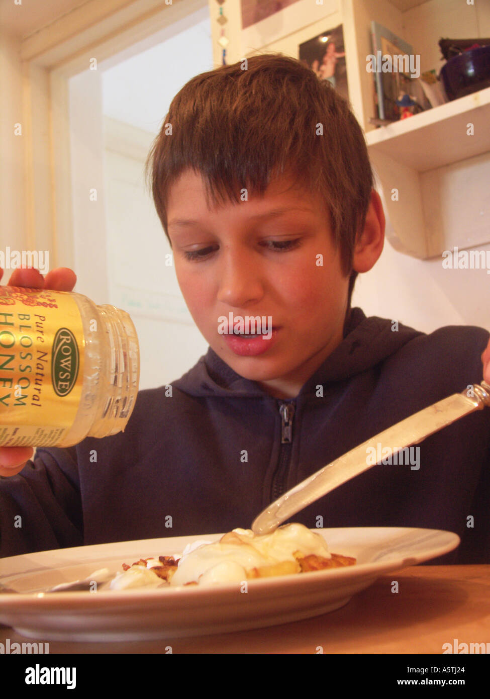 Boy eating a pancake Stock Photo Alamy