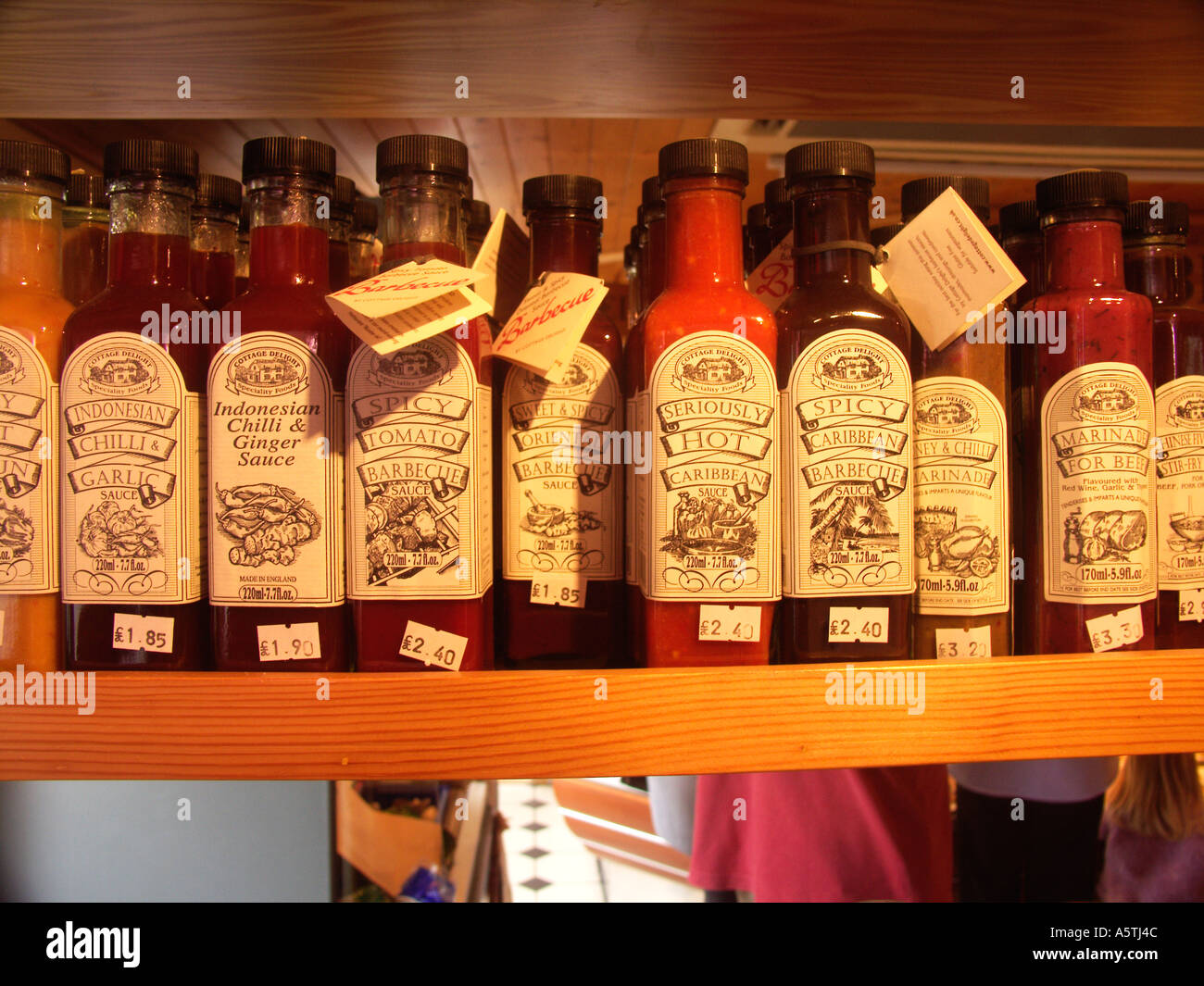 shelf-of-spicey-sauces-on-display-in-english-butcher-s-shop-stock-photo