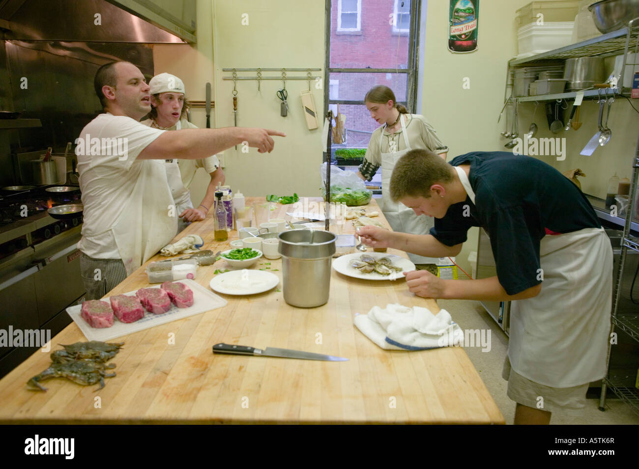A chef and assistants cooking in a busy restaurant Canajoharie New York Montgomery County Stock