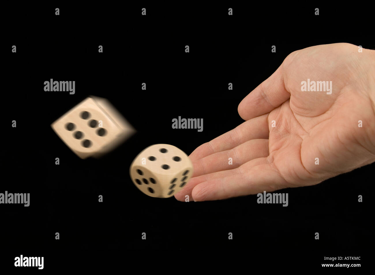 hand throwing dice rolling dice Stock Photo Alamy