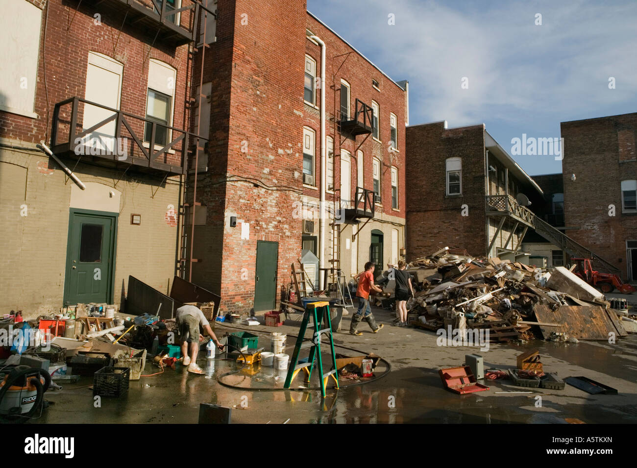 Townspeople and volunteers pile debris after flooding of Mohawk River