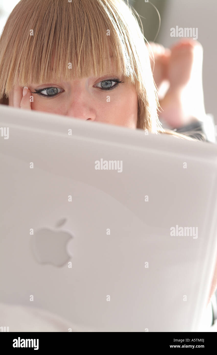 young female using laptop computer in bedroom Stock Photo Alamy
