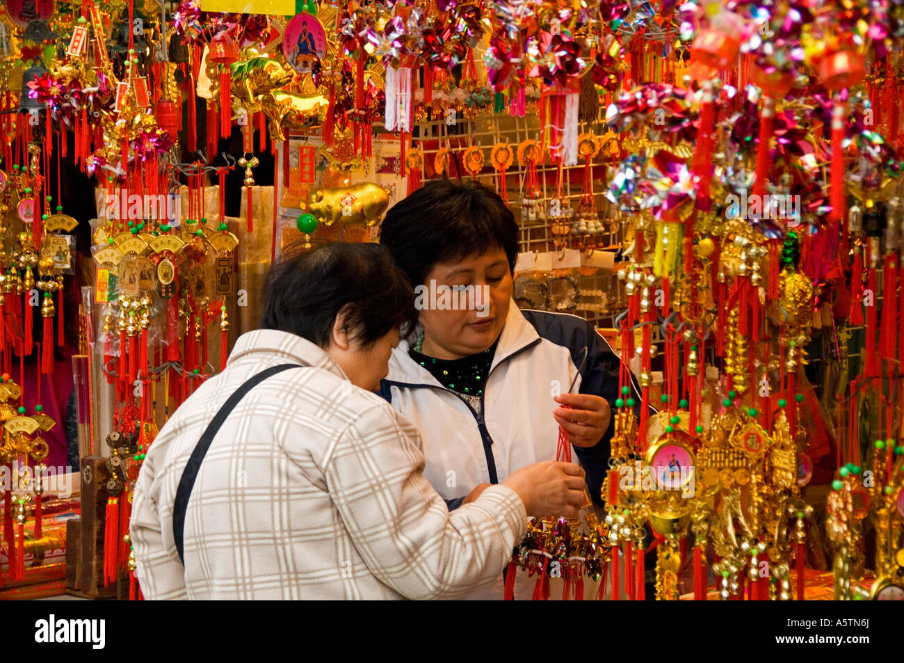 Customers on Chinese Trinket Stall Outside Wong Tai Sin Temple, Kowloon, Hong Kong, Asia Stock Photo