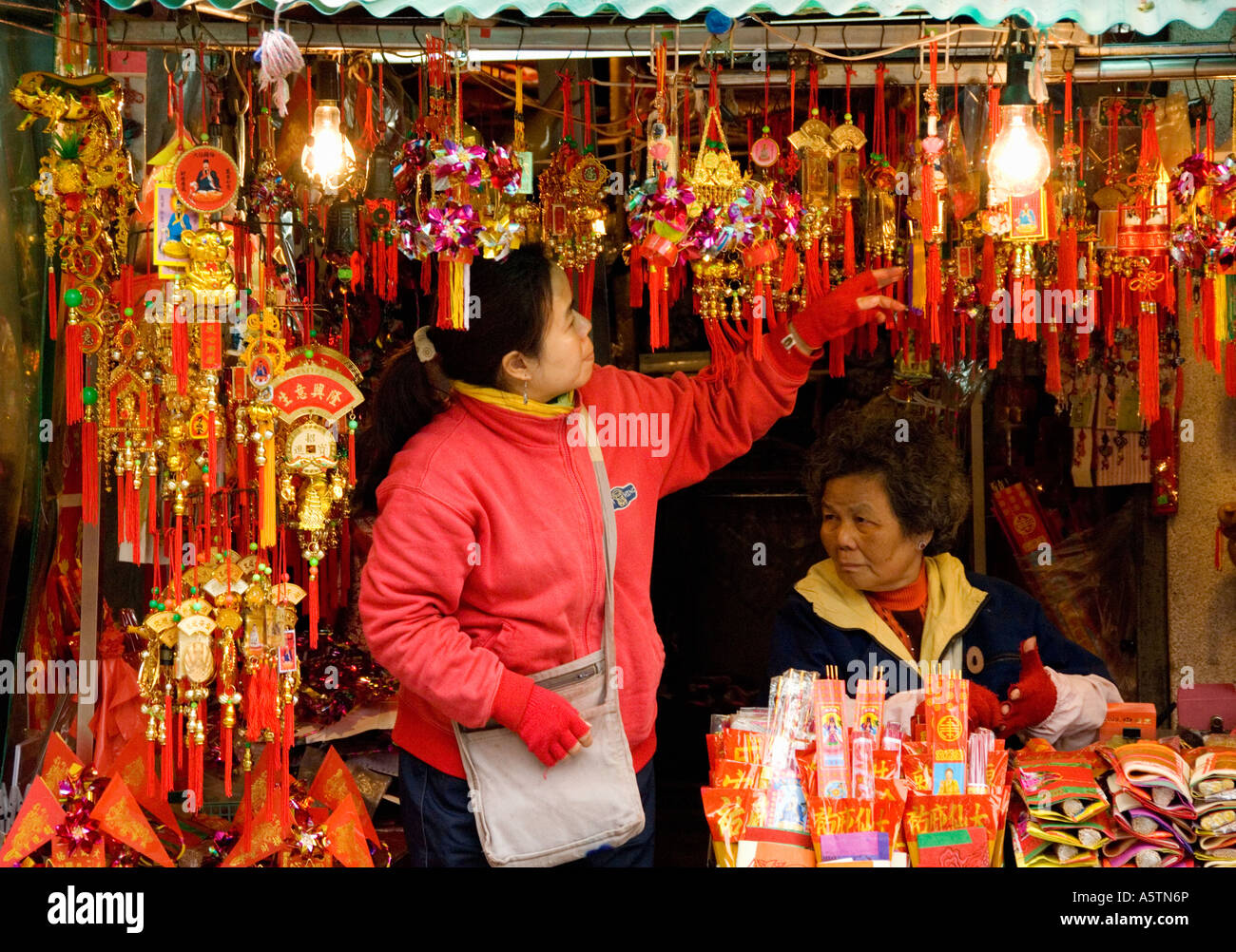 Market Traders on Chinese Trinket Stall Outside Wong Tai Sin Temple, Kowloon, Hong Kong, Asia Stock Photo