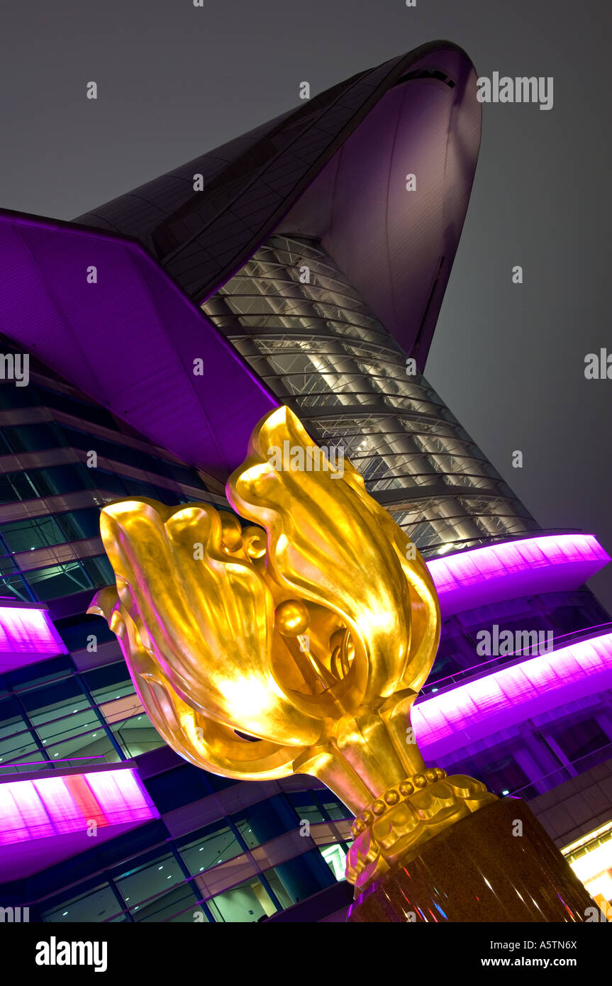 The Forever Blooming Golden Bauhinia Sculpture and Hong Kong Exhibition  Centre at Night, Wan Chai, Hong Kong, China Stock Photo