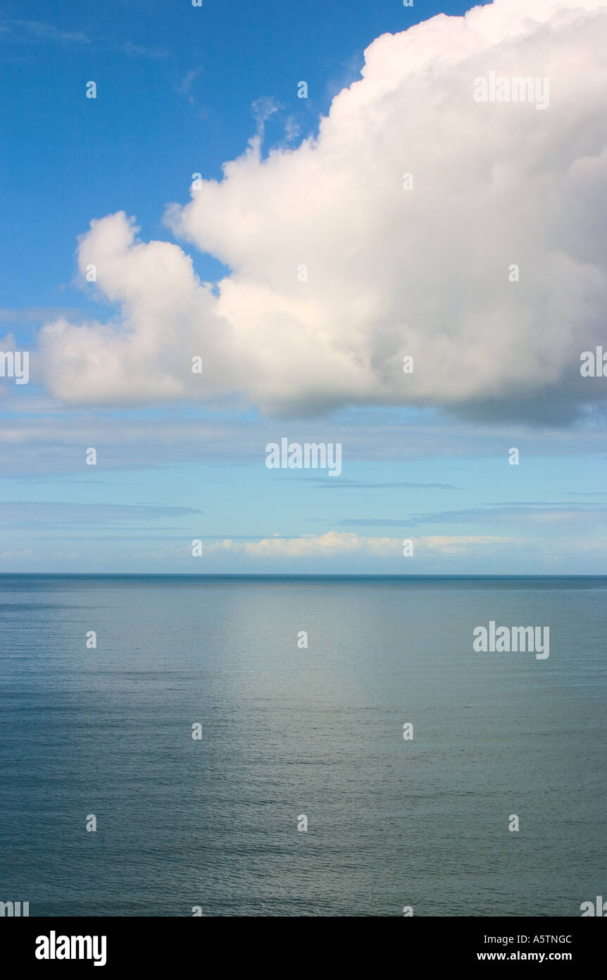 A calm sea with floating amorphous cloud above Stock Photo - Alamy