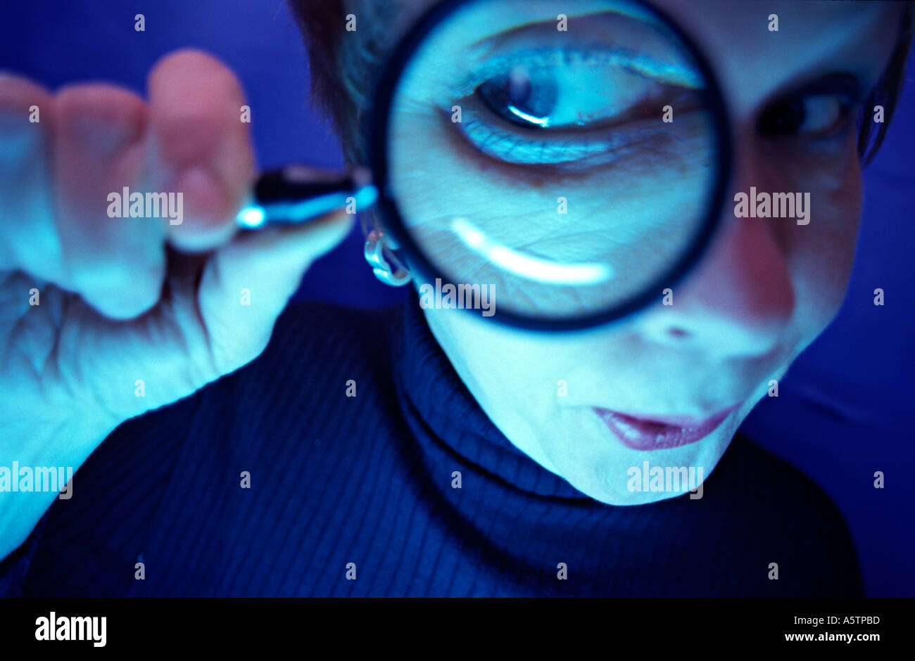 MR woman looking through a magnifying glass Stock Photo - Alamy