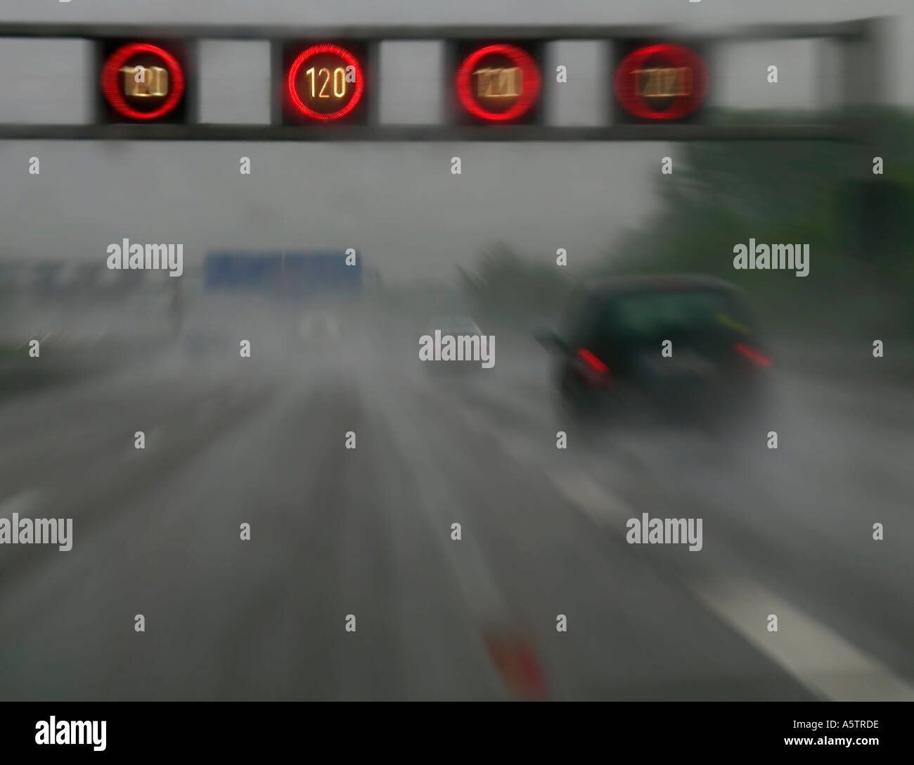 electric signs for speed limit above a moroway with bad sight on rainy ...