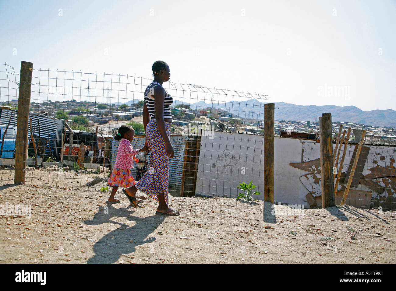 Painet jj1718 namibia woman female child kid walking slum district katatura windhoek 2 africa subsahara poverty apartheid Stock Photo