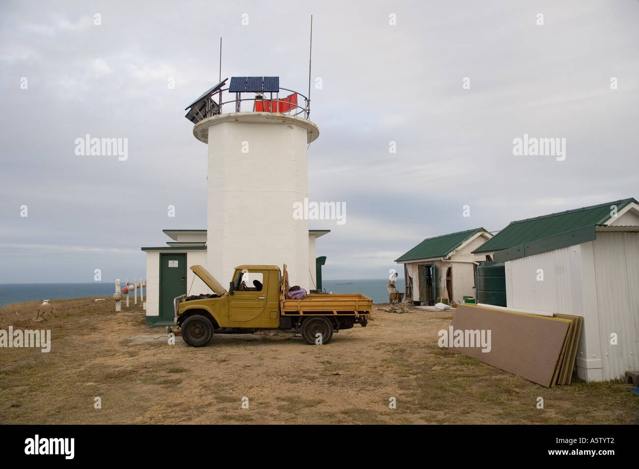 Old truck next to lighthouse Stock Photo