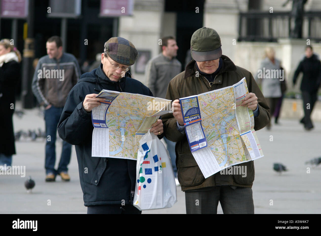 Tourists looking at map. Trafalgar Square, London, England Stock Photo