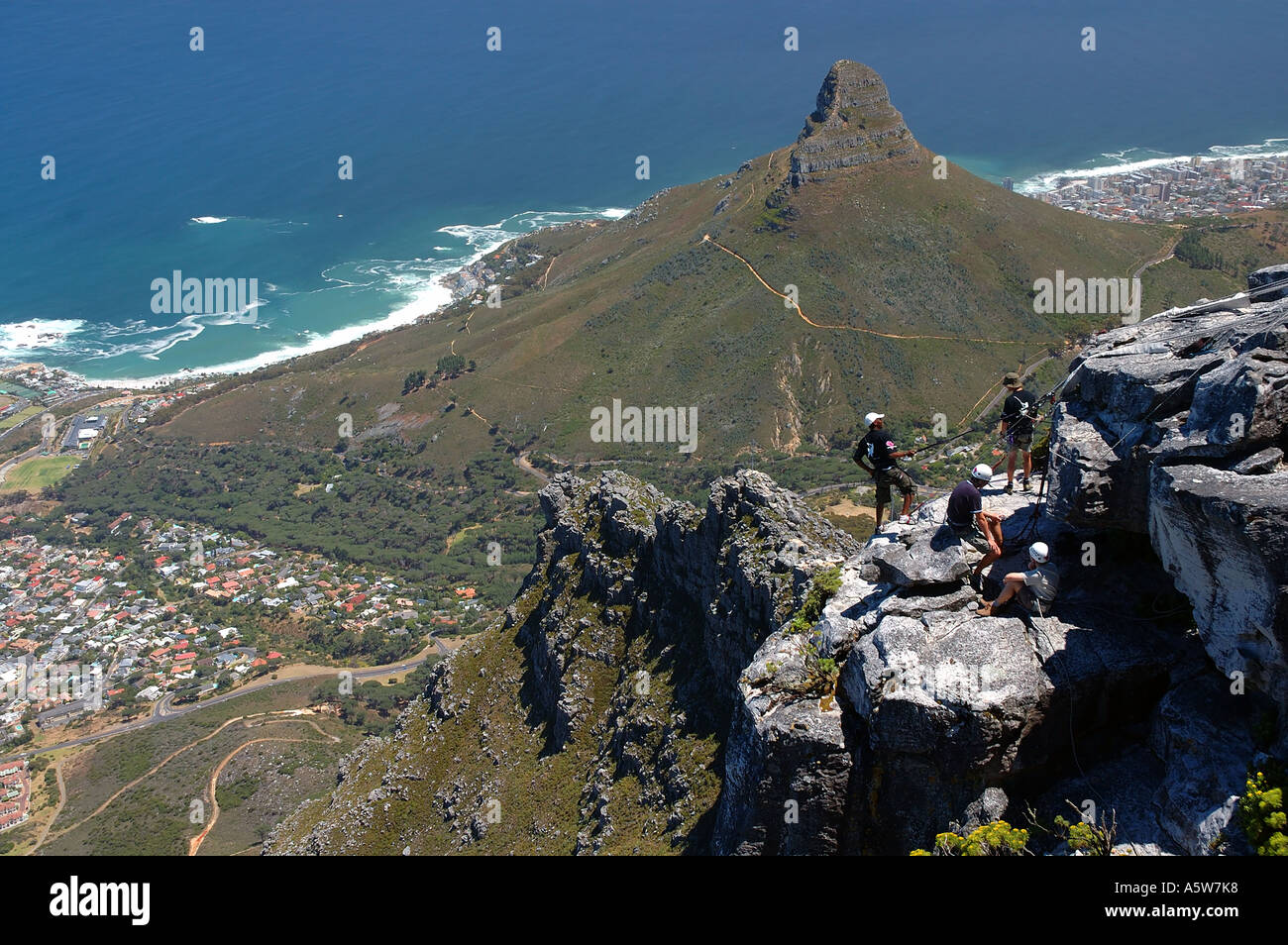 Abseiling group on the slopes of Table Mountain with the Lion's Head in the background Stock Photo