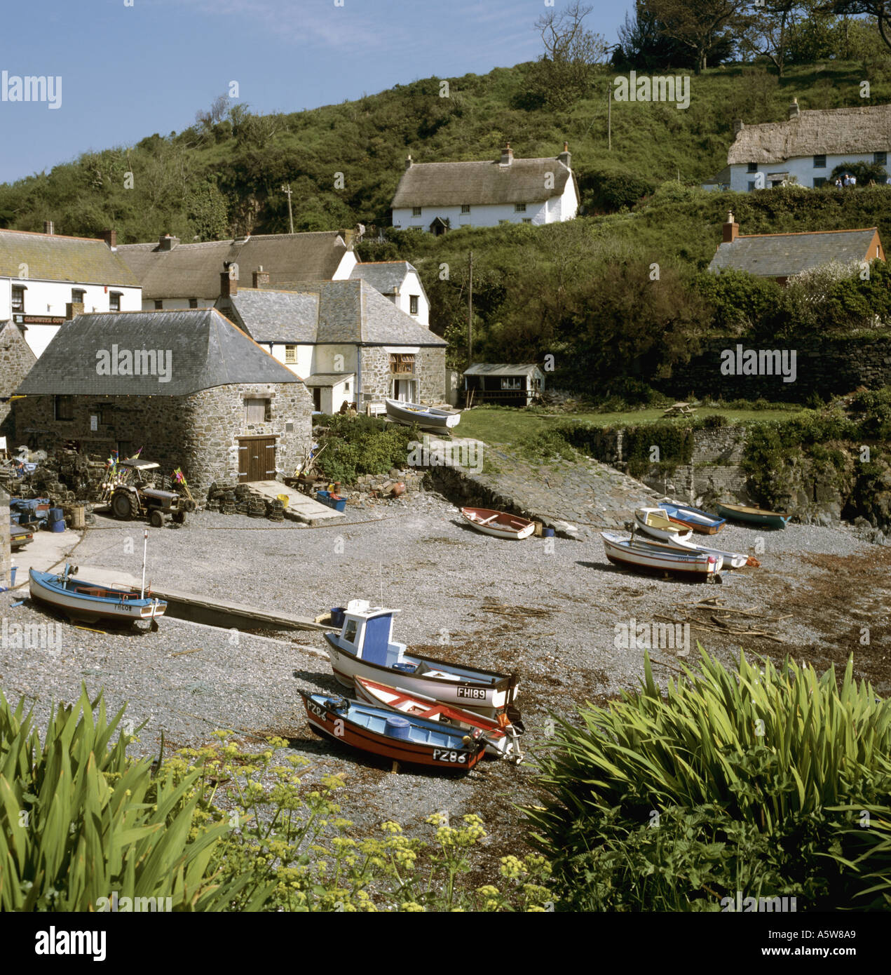 Fishing boats on the beach at Cadgwith Cove in Cornwall in the UK Stock Photo