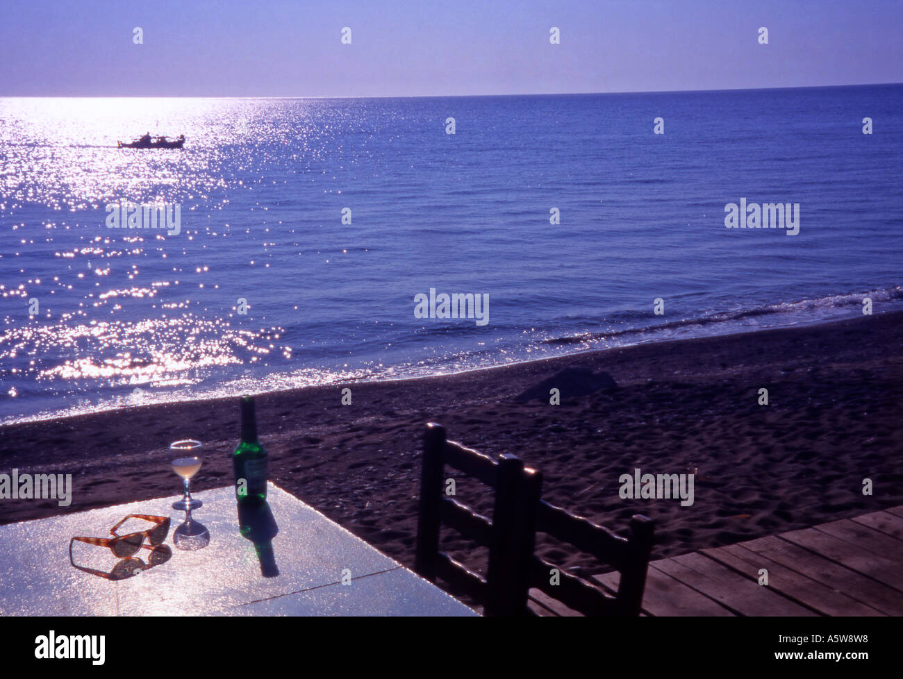 Greece Lesvos Glass of wine on a beachfront table Skala Eressos Stock Photo