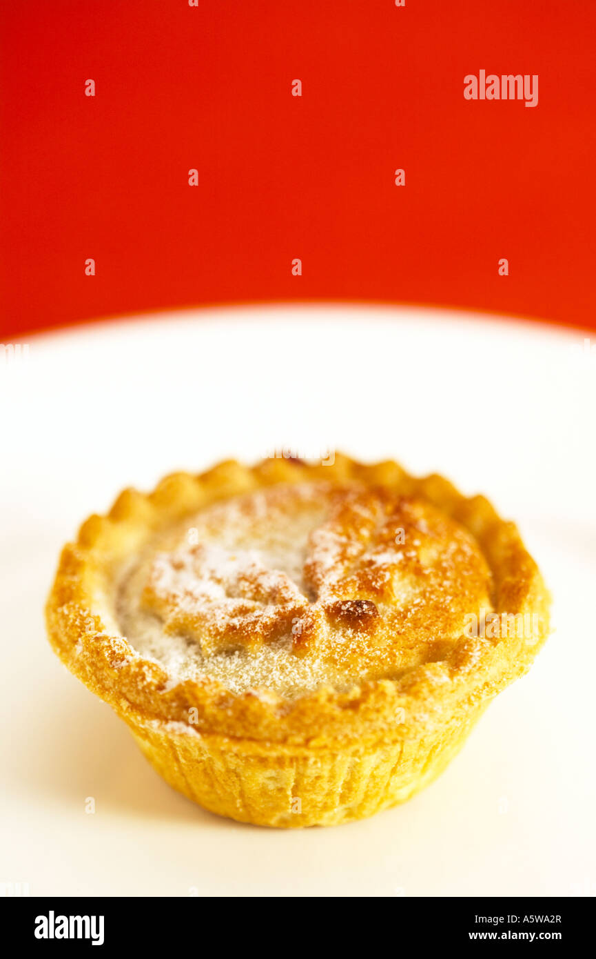 mince pie on white plate with red background Stock Photo - Alamy