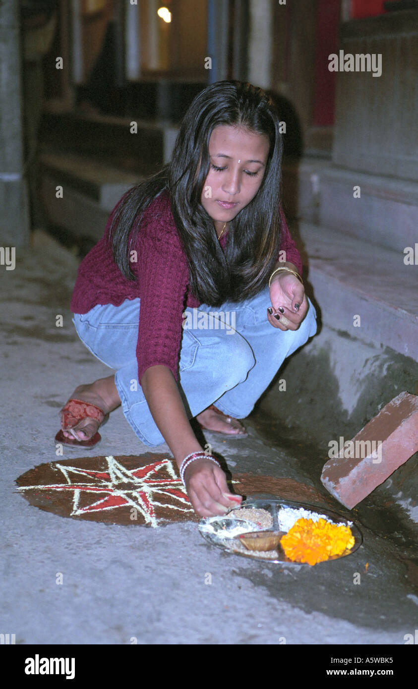 Portrait Of Nepali Girl Preparing Ritual Offering At Tihar Fistival Of Lights Third Day