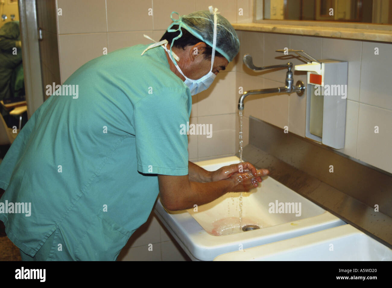 Surgeon washing his hands before practicing surgery in an operating