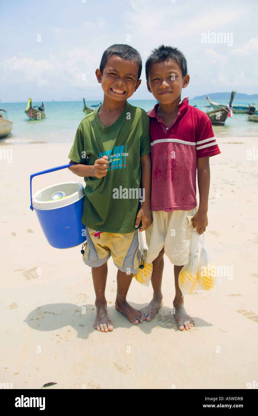 Thai boys selling pineapple Railay Beach West Thailand Stock Photo
