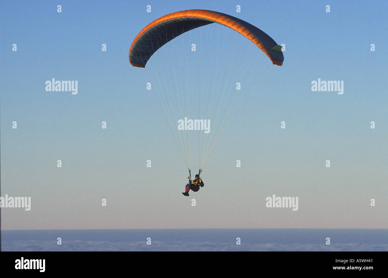 paragliding above the clouds Stock Photo